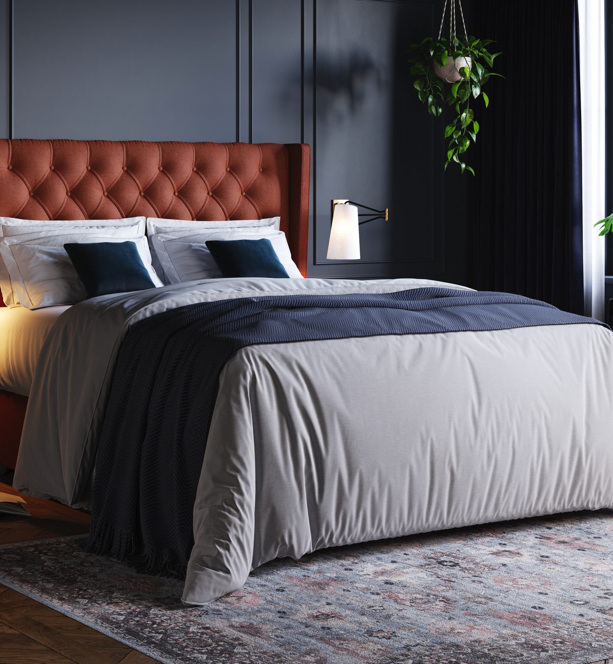 Harrison Spinks bed from the British Luxury Collection, with an upholstered headboard, in a navy-walled bedroom