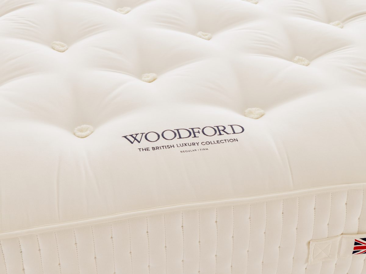 Close-up of the tufting and embroidered label of the Harrison Spinks Woodford mattress